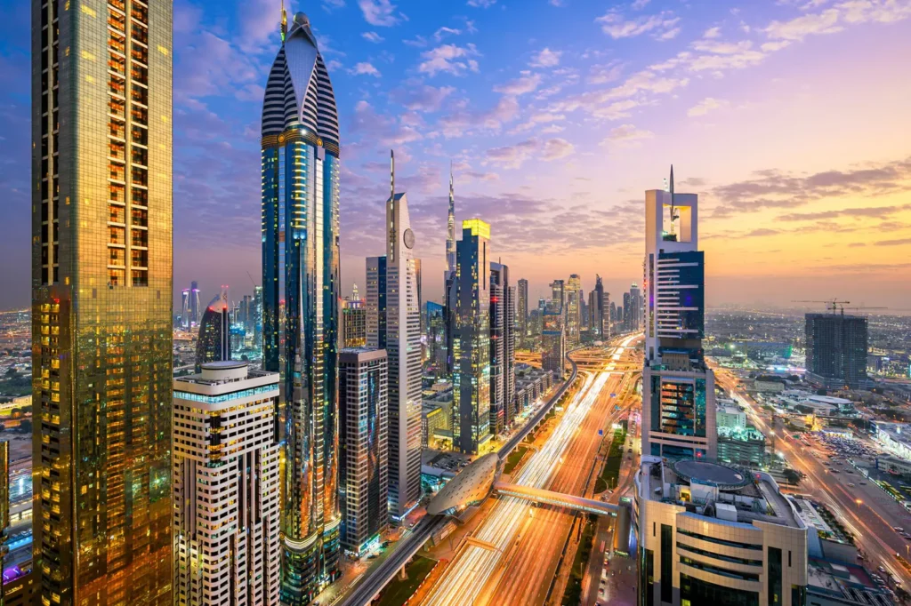 Dubai skyline with the sun shining.